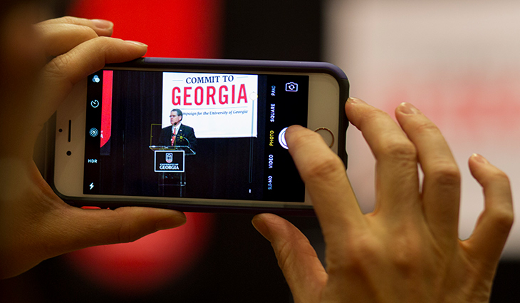 Someone taking a photo on their smartphone.