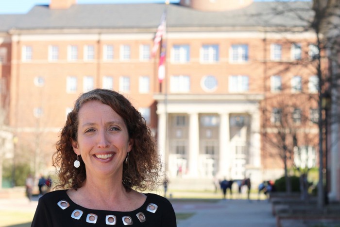 Mary Eberhard's headshot in front of Miller Learning Center.