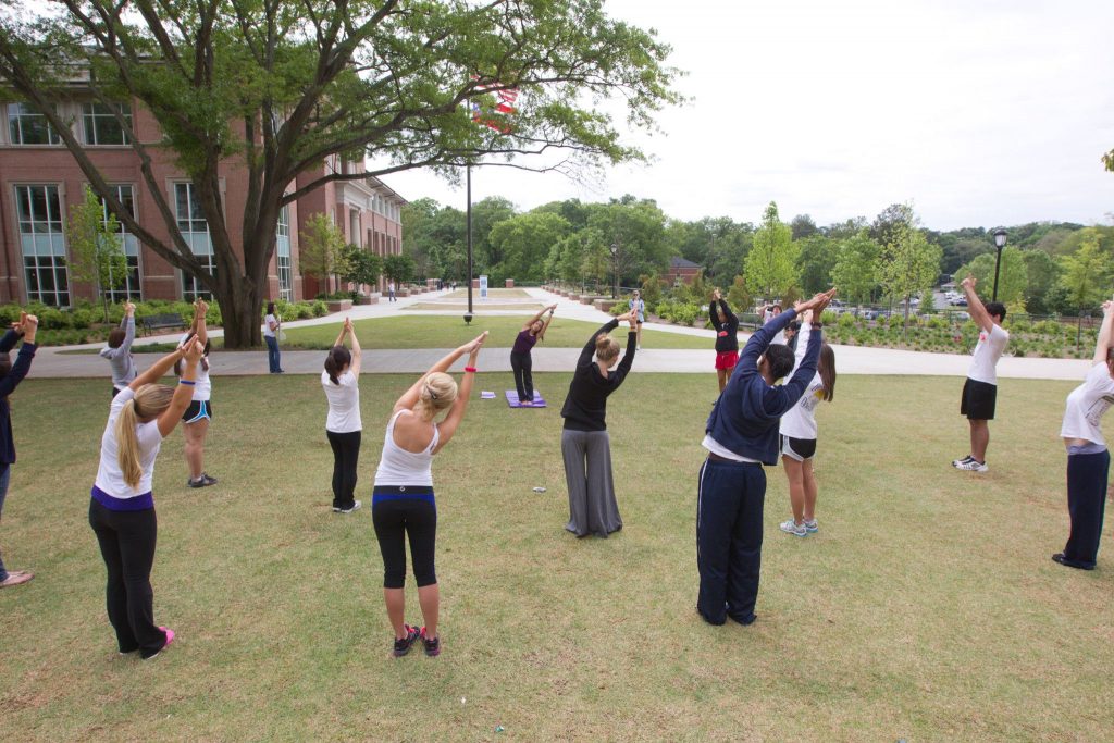 Multiple students doing yoga.