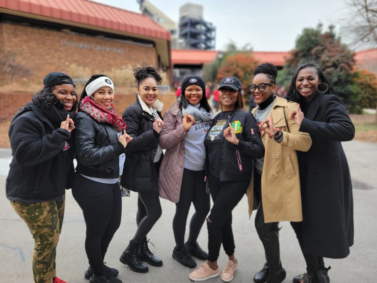 Multiple students standing outside the University bookstore.