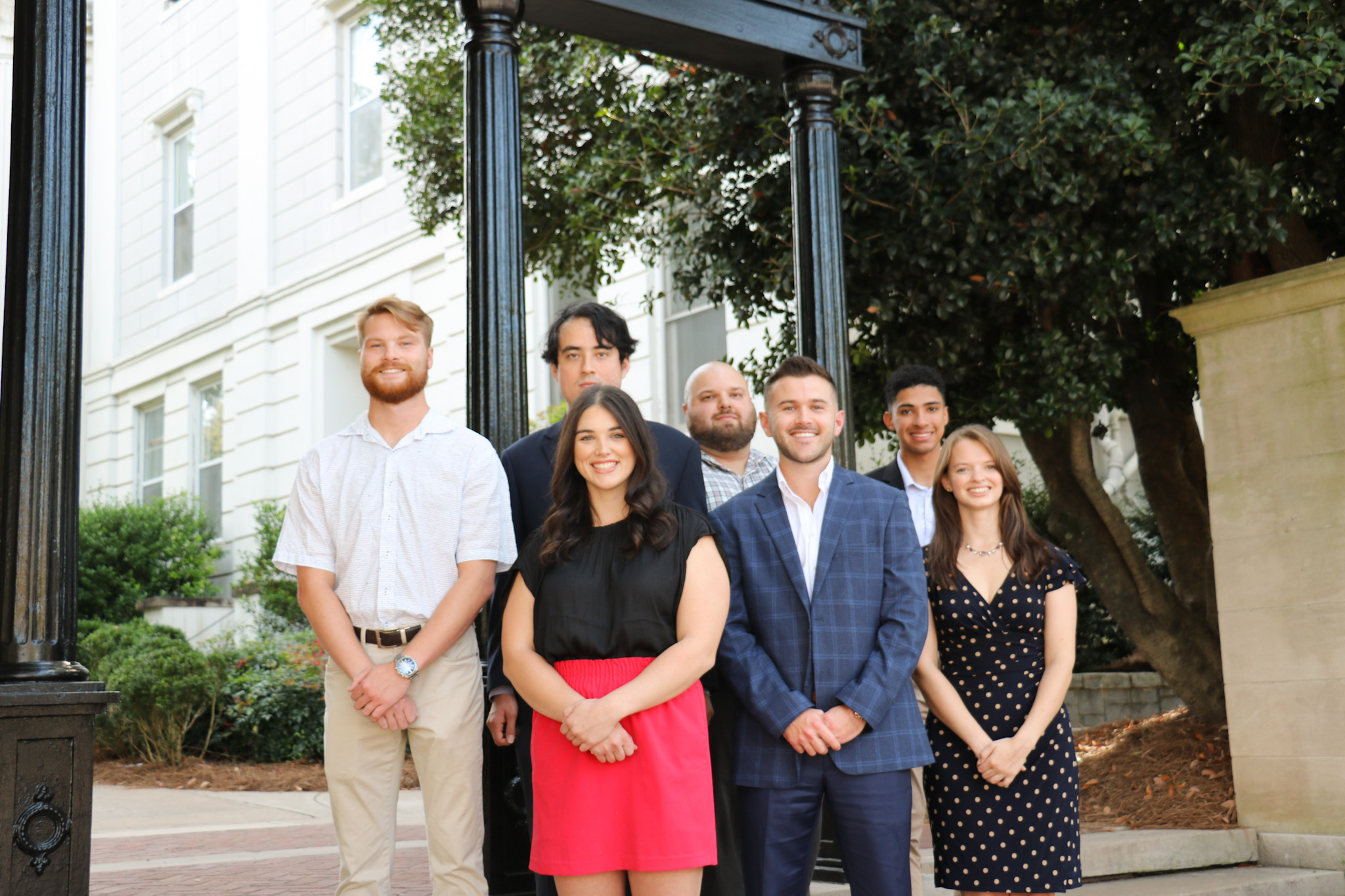 Seven student veterans stand in front of UGA arch