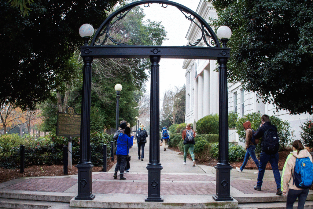 The UGA arch with students walking behind.