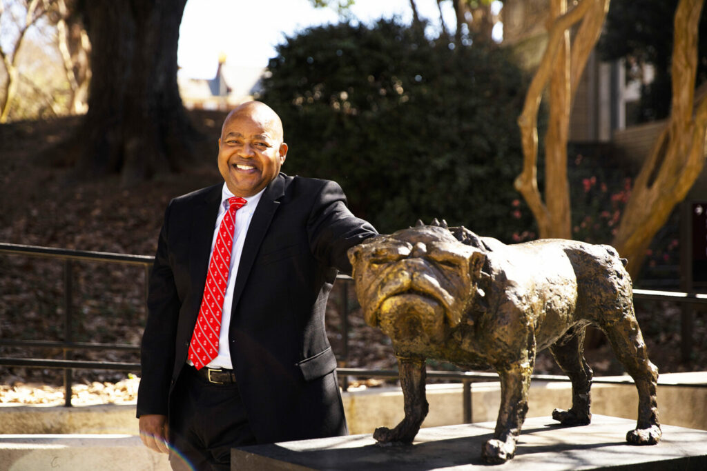 Victor Wilson next to a UGA statue.