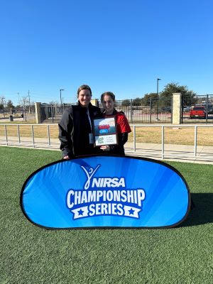 Two people holding a Nirsa Championship Series sign.