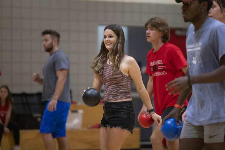 Undergraduate Brooklen Latka, middle, laughs as she plays dodgeball in gym central during Ramsey Palooza. (Photo by Andrew Davis Tucker/UGA)