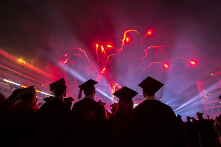 Students viewing a fireworks display during the UGA commencement ceremony.