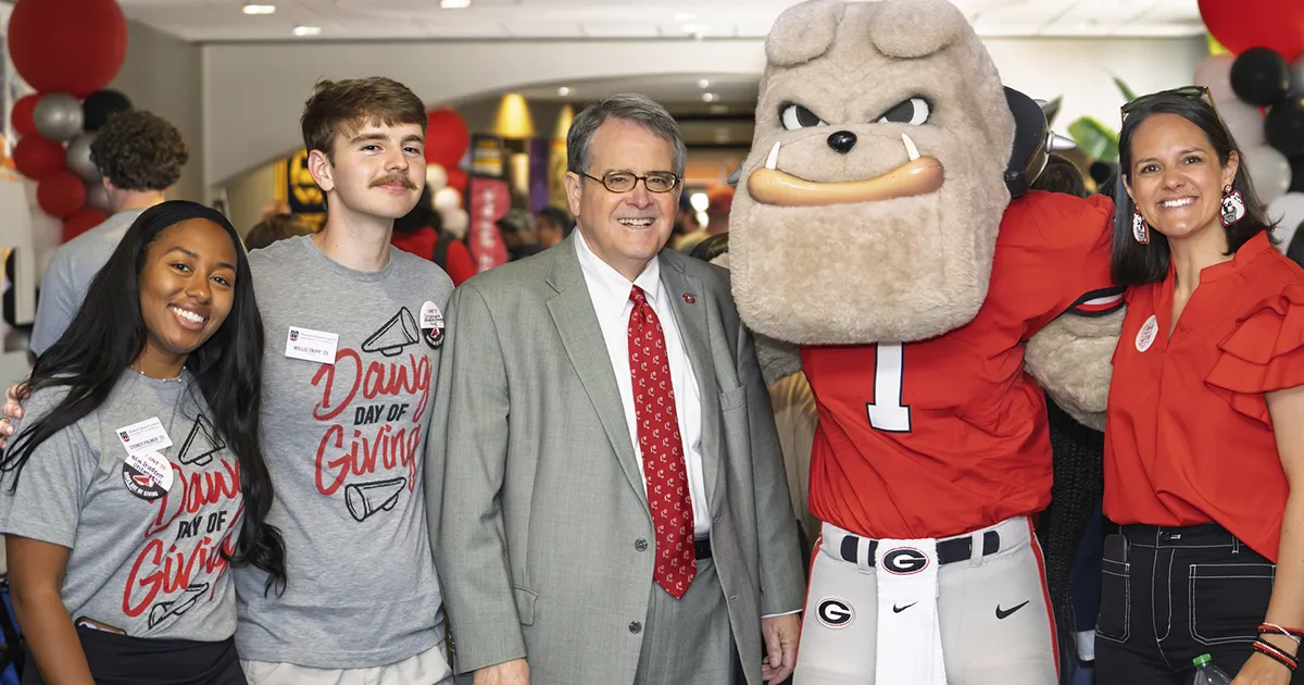 Students and president Moore with Hairy Dawg.