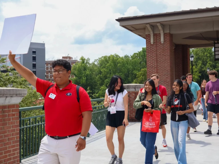 Esteban Lazaro leads his team into small groups outside Tate Student Center in Athens, Georgia on Wednesday, July 23, 2025. (Photo/ Hosanna Worku; @Hos.an.na)