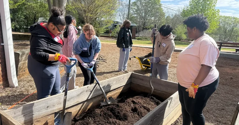 Several people doing service at Barrow Elementary for Dawg Day of Giving