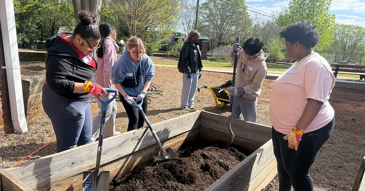 Several people doing service at Barrow Elementary for Dawg Day of Giving